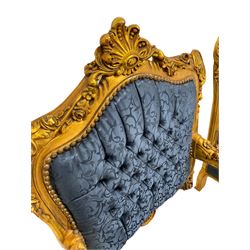 Pair French style gilt wood armchairs, the cresting rail decorated with shell and flower head motifs, upholstered in buttoned blue fabric with scrolling foliate pattern, floral carved cabriole supports