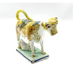 19th century Pratt type cow creamer with calf sponged in manganese and cobalt and on a rectangular pearl ware base H12cm x L13cm