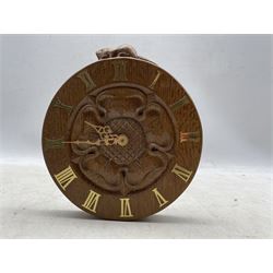 'Beaverman' carved oak wall clock with a central carved Yorkshire Rose and brass Roman numerals, Quartz movement, by Colin Almack of Sutton-under-Whitestonecliffe, H20.5cm