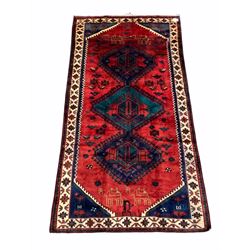 Persian Lorestan hand woven ground rug, triple medallion on red field decorated with stylised animals 277cm x 140cm