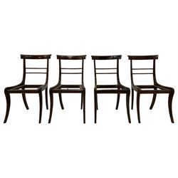 Set of eight Regency rosewood and beech dining chairs, the bar back with carved decoration and applied rosewood panels over two slender middle rails, on sabre supports, the carver with scrolled arms