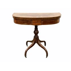 Regency mahogany fold over tea table, the bowed and cross banded top folding and revolving over boxwood strung frieze, raised on turned supports and four inverted splayed supports with castors W91cm