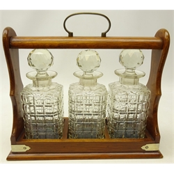  Early 20th century oak three bottle tantalus with silver-plated mounts and brass handle, L35cm x H31cm  