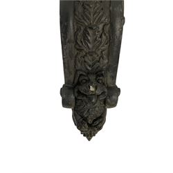 Medieval design ebonised corbel, the top section with a moulded scaly grotesque with mouth agape and pointed ears, the lower with concave arch surrounding an armoured knight in prayer, the sides of the corbel decorated with moulded flower heads and foliate patterns; Medieval design ebonised corbel, the cavetto top over a grotesque elf in medieval tunic with hood; Medieval design ebonised corbel, the capital moulded with arcade patterns, the scrolled body decorated with central repeating acanthus leaf design, terminating in a gryphon mask (3)