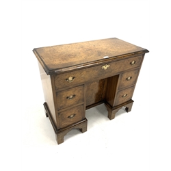 Early 20th century Georgian style burr walnut kneehole desk/dressing table, cross banded top over one long drawer and two banks of two short graduated drawers, enclosing cupboard, raised on shaped supports, W86cm, H72cm, D42cm