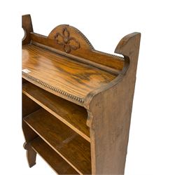Early 20th century oak open bookcase, raised back with beaded edge and applied floral motif over two shelves