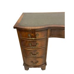 Georgian design mahogany two pedestal desk, serpentine top with inset leather, fitted with nine drawers, on bracket feet