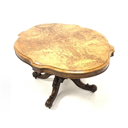Victorian burr walnut loo table, the well figured quarter sawn veneered serpentine top raised on turned pedestal and four leaf carved and splayed supports terminating in ceramic castors, 113cm x 150cm, H175cm