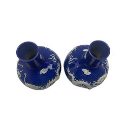 Pair of Yuan style Chinese blue glazed bottle shaped vases each decorated in high relief with dragons amidst cloud and flame scrolls, bearing Yung-Cheng mark beneath H31cm 