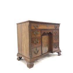 Georgian style mahogany kneehole writing desk, cross banded top over one long, six short and one concealed drawer with cupboard to centre, blind fretwork to the canted corners, raised on ogee bracket supports W97c, H83cm, D51cm