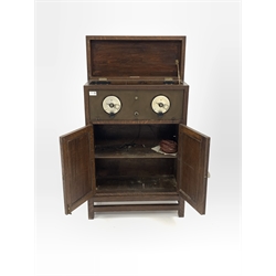 Early 20th century radio receiver, bearing ivorine plaque reading 'This instrument is licenced under Marconi patents for the reception of broadcasting ' fitted with three glass valves, in oak case