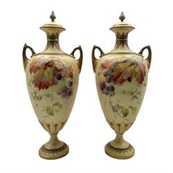 Pair of late Victorian Royal Worcester two handled baluster vases and covers painted with fruit, leaves, spiders etc on a blush ivory ground on a short pedestal foot, date code 1896/7 H34cm 