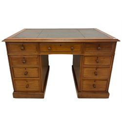Late 19th century mahogany twin pedestal desk, rectangular top with leather inset writing surface, fitted with central frieze drawer flanked by eight graduating drawers, lower moulded edge over plinth base and castors, each pedestal fitted with faux cupboards to the reverse