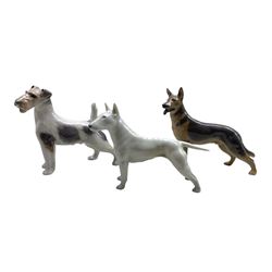 Royal Copenhagen porcelain dogs comprising Bull Terrier no. 3280, German Shepherd no. 3261 both designed by Theodor Madsen and a Wired Haired Terrier no. 2967 (3)