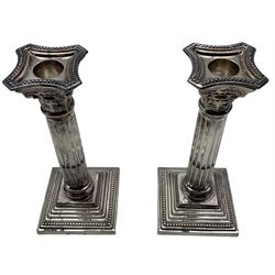 Pair of silver Corinthian column table candlesticks on stepped square bases with beaded sconces H20cm London 1974 Maker A Chick & Son