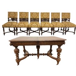 Victorian oak dining table, the wind out top over carved frieze, raised on carved balusters united by a stretcher terminating in castors with two leaves, together with six dining chairs of similar design 