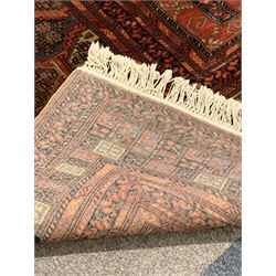 Large Afghan carpet, the deep red field decorated with geometric designs, guls and bordered 300cm x 406cm