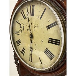 A 19th century English single fusee eight-day wall clock in a mahogany case with a 16” diameter wooden bezel and 12” painted steel dial pinned directly to the movement, Roman numerals and minute track, pierced steel hands and cast brass bezel with a flat glass, drop dial case with carved ear-pieces and carved surround to the pendulum viewing glass, curved base with pendulum regulation door and two case doors, makers name indistinct.
With pendulum.   
H 60
