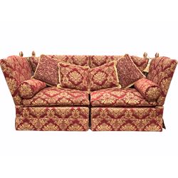A large Knole drop arm two seater sofa, upholstered in red floral damask fabric, with squab and baluster cushions (W251cm, H108cm, D97cm)