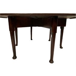 Late 18th century oak six legged drop leaf dining table, raised on turned supports, terminating in pad feet