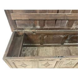 18th century oak coffer or chest, rectangular hinged panelled top with moulded frame enclosing candle box, the frieze carved with foliate S-scrolls over a quadruple panel front decorated with carved lozenges, on stile supports
