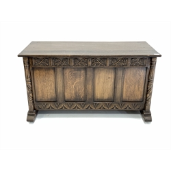 20th century medium oak blanket box with hinged top over floral carved frieze, four panel front and fluted and spiral turned pilasters 