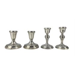 Pair of silver candlesticks with circular bases H12cm Birmingham 1926 and another pair H10cm (4) 