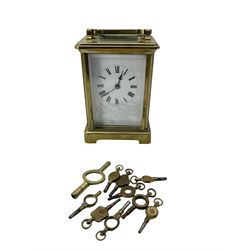 French - early 20th century 8-day carriage clock c1910, in an anglaise case with rectangular bevelled glass panels and an enamel dial, Roman numerals, pierced steel hands and minute markers, timepiece movement with a silvered lever escapement. With winding key and an assorted selection of pocket watch keys.
