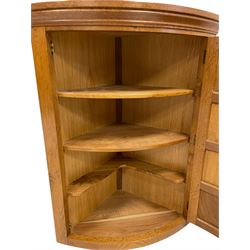 'Beaverman' oak bow front corner cupboard, moulded cornice over bowed panelled door, the upright carved with beaver signature, the interior fitted with three shelves, by Colin Almack of Sutton-under-Whitestonecliffe