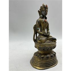 Chinese bronze figure of a Deity, in Ming style, seated wearing flowing robes and diadem on lotus base, with traces of polychrome gilt decoration H24.5cm, together with a Tibetan gilt bronze deity, inset with turquoise and coral coloured stones, on double lotus base (2)