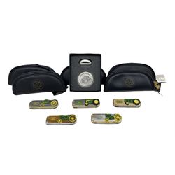 Five John Deere folding collectors knives by Franklin Mint, each housed in a faux leather pouch, together with a John Deere medallion with stand, boxed (6)