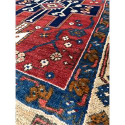 Persian Heriz runner rug, the central red field with three geometric medallions, enclosed by multi line border 300cm x 100cm
