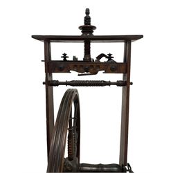 Late 19th century stained beech spinning wheel, carved decoration to the shaped frieze, the wheel with eight bobbin-turned spokes attached to a ring turned arbor with steel pivots