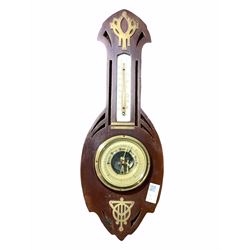 Early 20th century mahogany cased aneroid barometer and thermometer in the Secessionist style, the pierce carved case with brass mounts, enclosing ivorine registers H52cm