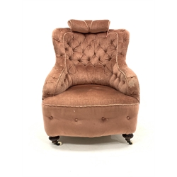 Victorian sprung back armchair, upholstered in buttoned pink velvet, raised on turned mahogany supports terminating in ceramic castors, W72cm