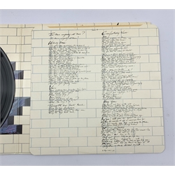Two Pink Floyd LPs comprising 'Animals' with card inner with rounded edge, large thumb notch at top and catalogue number at bottom right hand inner, matrix numbers SHVL 815 A-2U/B-3U and 'The Wall' with inners and stickered sleeve, matrix numbers SHSP 4111A-3U/B-3U, in protective plastic wallets (2)
