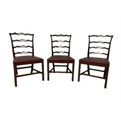 Set six Hepplewhite design mahogany dining chairs, the pierced and waived cresting rail with scrolled foliate carved decoration over ribbon ladder back, seats upholstered in chestnut leather, raised on chamfered supports united by H-stretcher