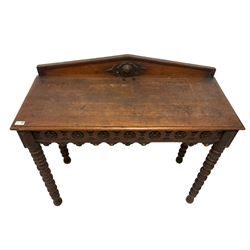 Late 19th century carved oak console or side table, raised arched back, the frieze carved with repeating rosettes, raised on bobbin turned supports