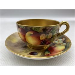 Pair of Royal Worcester tea cups and saucers by Edward Townsend, George Moseley and Harry Ayrton, each hand painted with a still life of fruit, signed H. Ayrton, H.G. Moseley and E. Townsend, with puce printed marks beneath and date codes for 1926 and 1928, saucer D12.5cm 