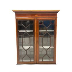 Edwardian mahogany Sheraton revival book case, the projecting cornice over two glazed doors of astragal design with satinwood bands, opening to reveal two adjustable shelves 