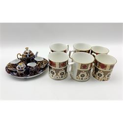 Roselle OCC & Co. miniature Imari pattern cabaret set, six Imari pattern tankards and a Gilt framed wall mirror, shaped and reeded frame enclosing bevelled plate 100cm x 71cm