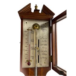 A 20th century mercury stick barometer in an earlier 18th century styled
Mahogany case with satinwood stringing to the edge, broken pediment, brass finial and round cistern cover, enclosed silvered register with Vernier recording barometric air pressure from 27 to 31 inches and weather predictions, Spirit thermometer indicating room temperature in degrees Fahrenheit, dial inscribed “Comitti Holborn” 




