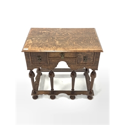 17th century style oak lowboy, fitted with three drawers, raised on turned supports united by shaped stretcher