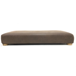 Large contemporary rectangular footstool, upholstered in brown leather, raised on compressed bun supports 