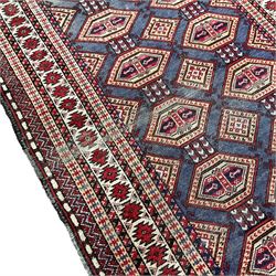Persian pale blue ground rug, the field decorated with two rows of interconnected lozenge motifs, the multi-band border decorated with geometric patterns 