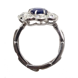 Early 20th century platinum sapphire and diamond cluster ring, the central oval sapphire with eight old cut diamond surround, on later 17ct white gold expanding shank