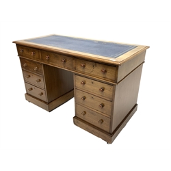 Victorian mahogany twin pedestal desk, the rectangular top inset with blue tooled leather writing surface, three frieze drawers over two banks of three graduating drawers, raised on castors