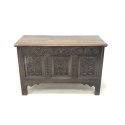 18th century oak coffer, the hinged lid over lunette carved frieze and three floral carved panelled front, raised on stile supports W115cm, H73cm, D54cm
