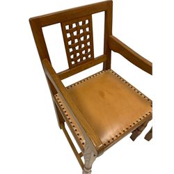 Knightman - pair of oak carver chairs, the lattice back panel over tan leather upholstered seat with stud work, raised on octagonal front supports, united by plain stretchers 