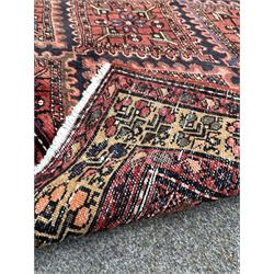Persian Kurdish red ground rug, the central field with repeating lozenge design and bordered 300cm x 168cm